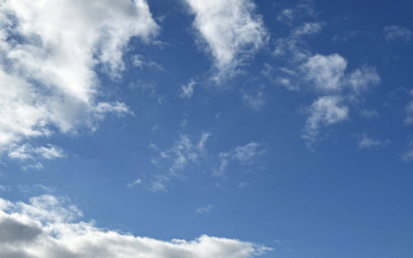 a blue sky with varied white clouds