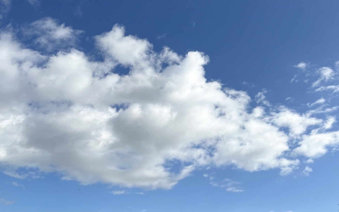 small white cumulus clouds against a blue sky