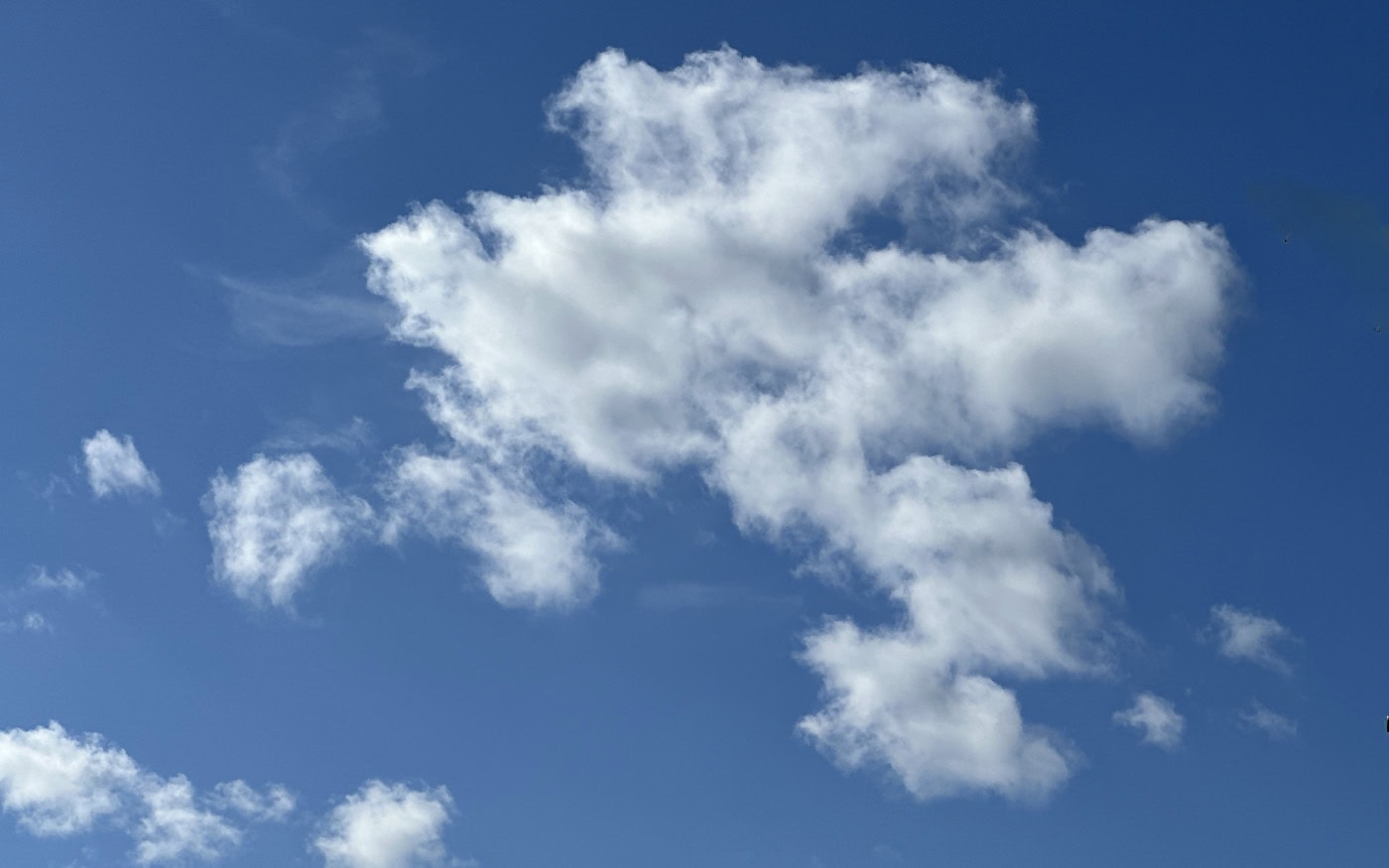 small, white, fluffy clouds against a blue sky, and a few high clouds
